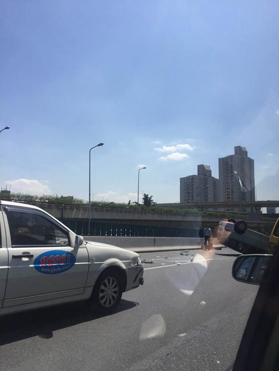 沪延安路高架一辆大众出租车被撞翻 乘客受伤送医